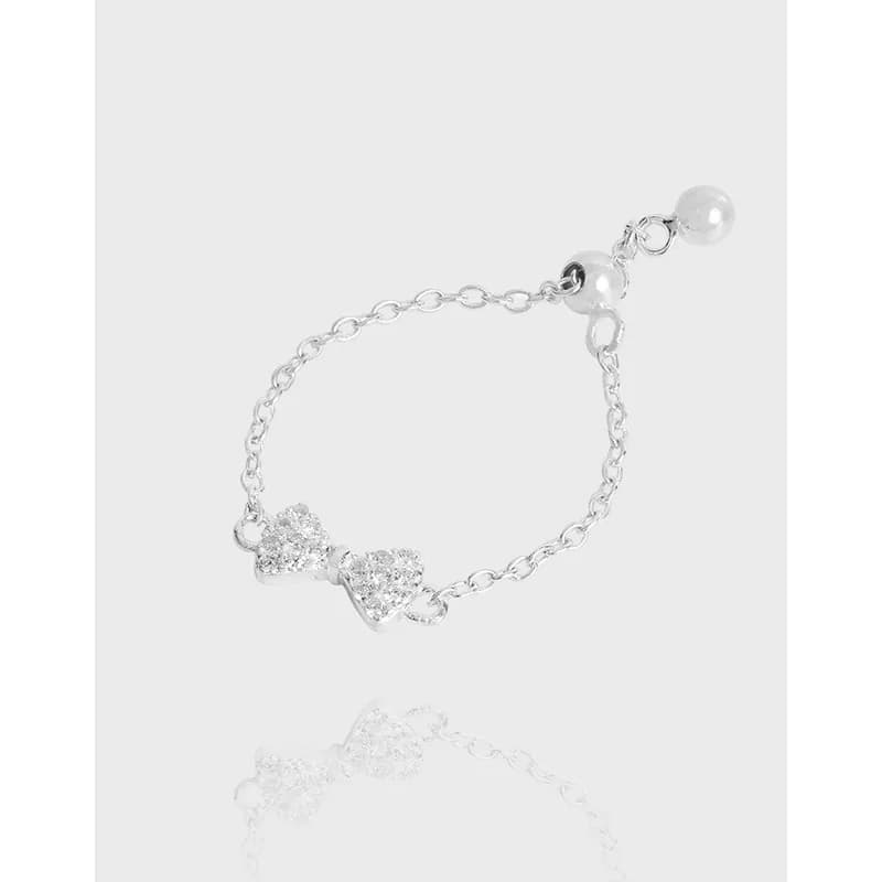Polished sterling silver ring with a delicate chain band and twin pavé-heart accents