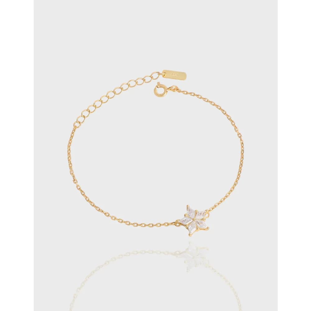 Delicate star pavé bracelet laid flat with a lobster clasp and chain extender visible.