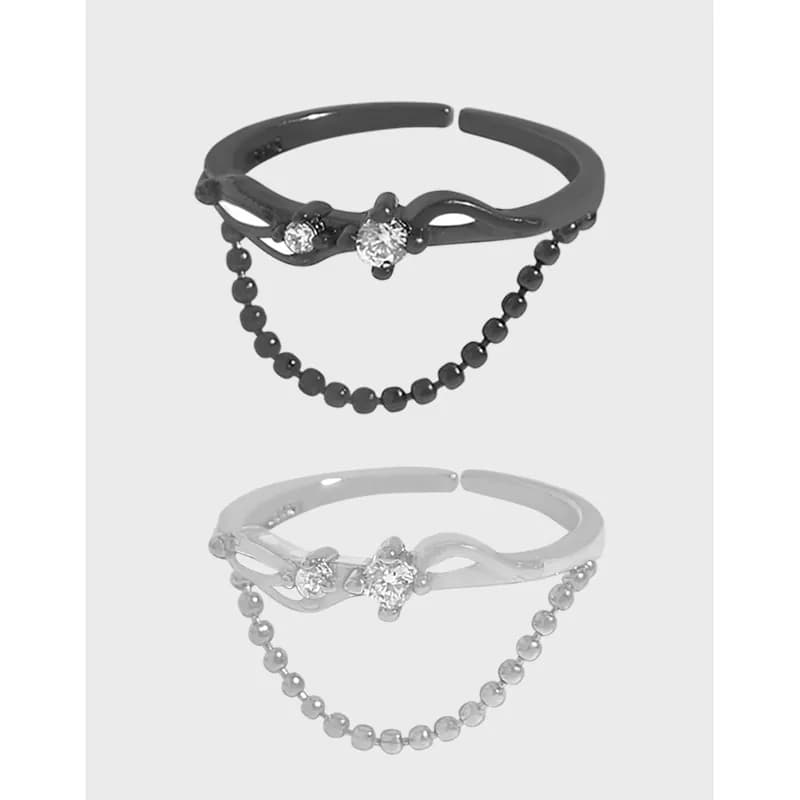 Polished sterling silver ring with twin stones and a dangling beaded chain detail