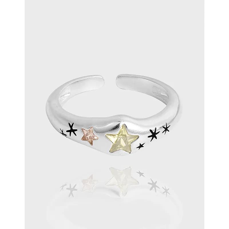 Polished sterling silver open ring with star motifs and two-tone star accents along the front.