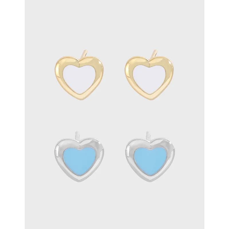 Two-tone heart-shaped stud earrings in gold-tone and silver-tone finishes with white and blue enamel centers.