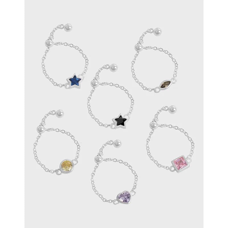 Polished Sterling Silver Chain-Link Ring with pearl ends and removable charm sits on a finger.