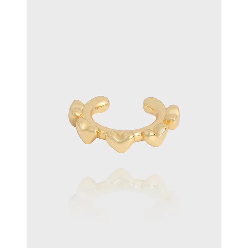 Polished sterling silver ear cuff with five small heart shapes arranged along a curved band.