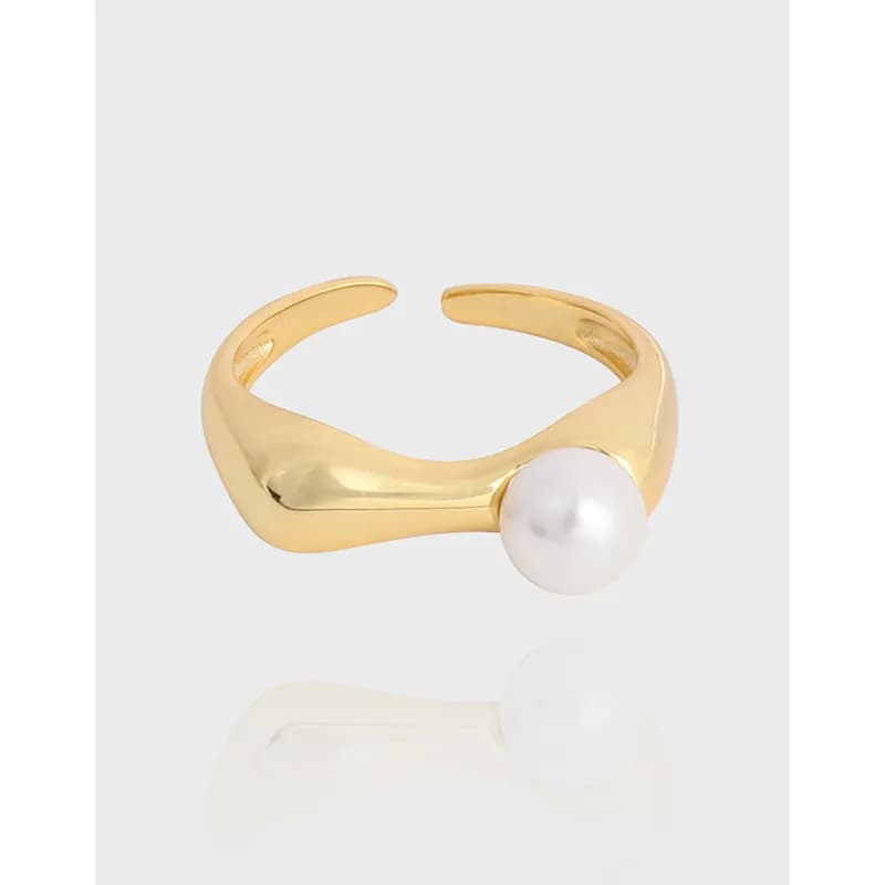 Polished open silver ring with a single white pearl accent on the outer edge.