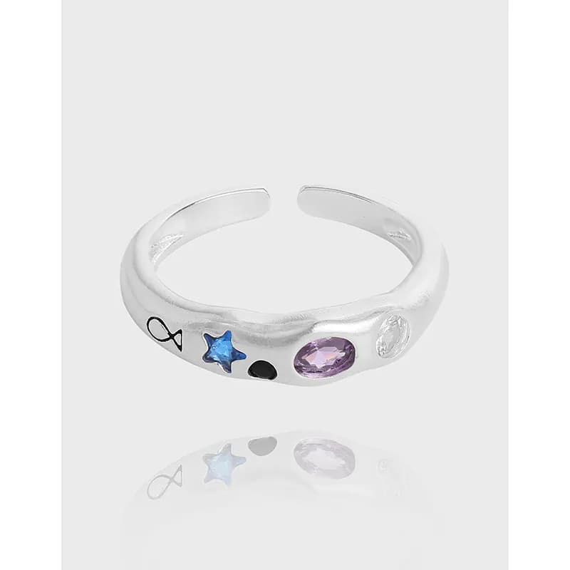 Polished sterling silver open-ring with blue star and purple oval gems along the band.