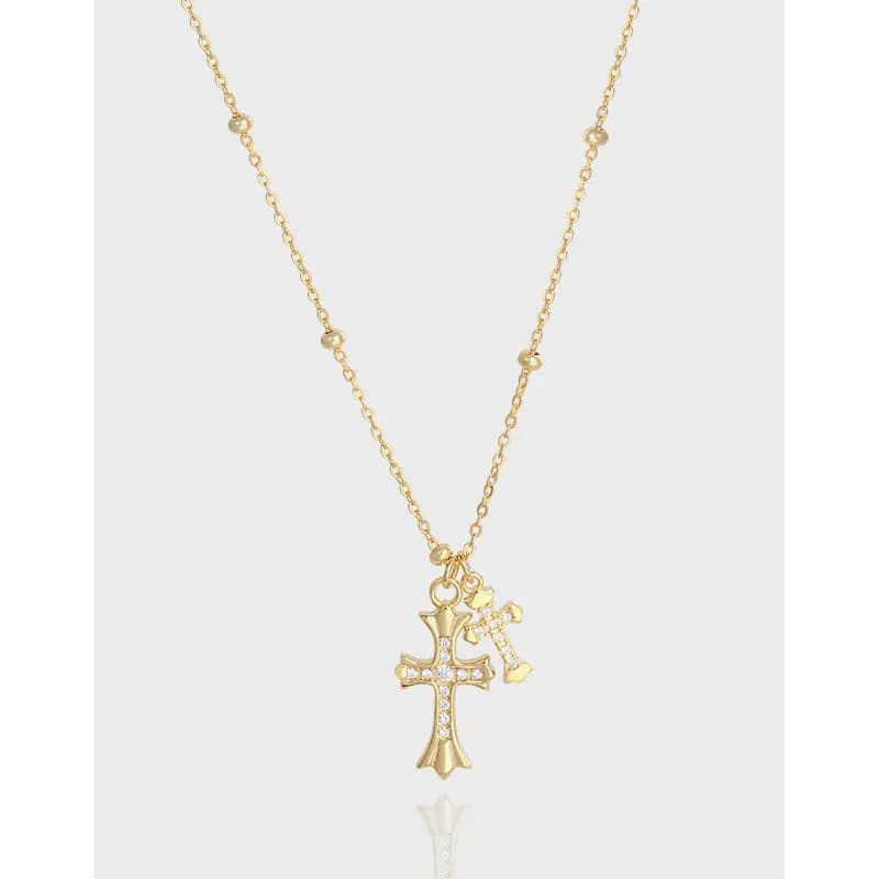 Gold-toned necklace with a larger jeweled cross pendant and a smaller cross charm on a delicate chain.