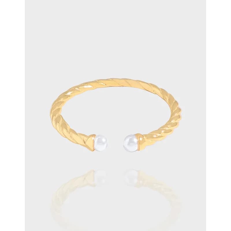 Open-ended twisted rope ring with pearl-like end beads on a light background.