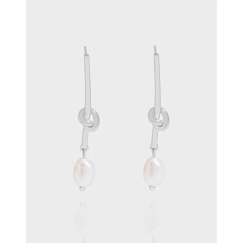 Sterling silver Pearl Drop Earrings with elongated bar and circular link detail, hanging with freshwater pearls.