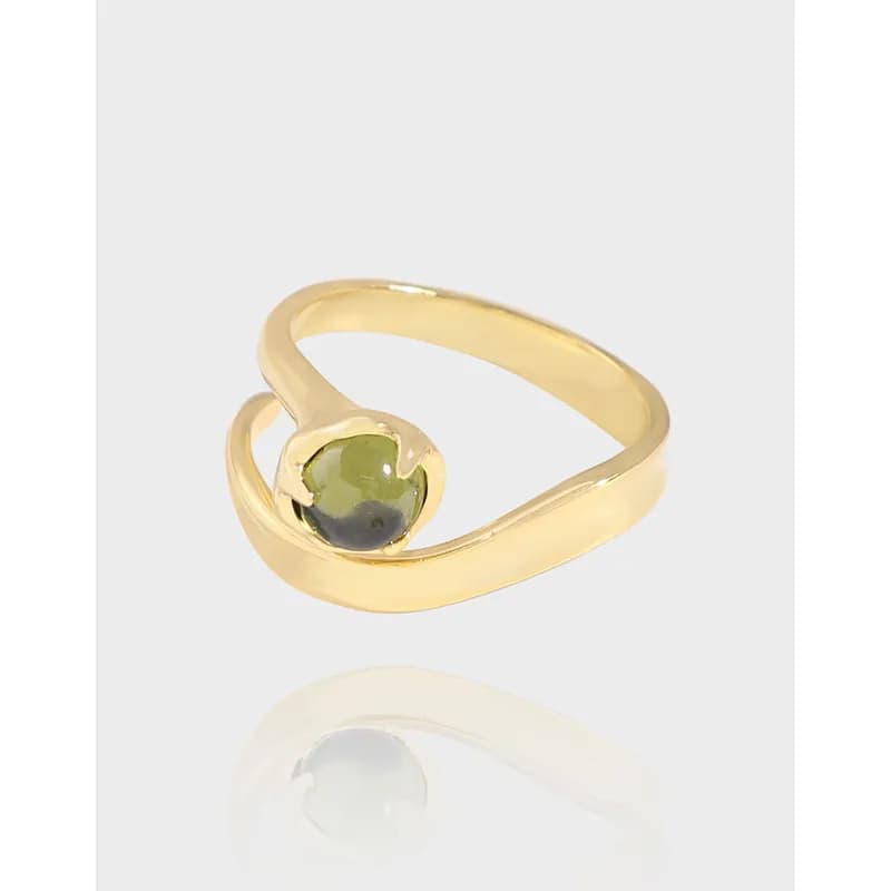 Polished sterling silver open wrap ring with a bezel-set green cabochon gemstone.