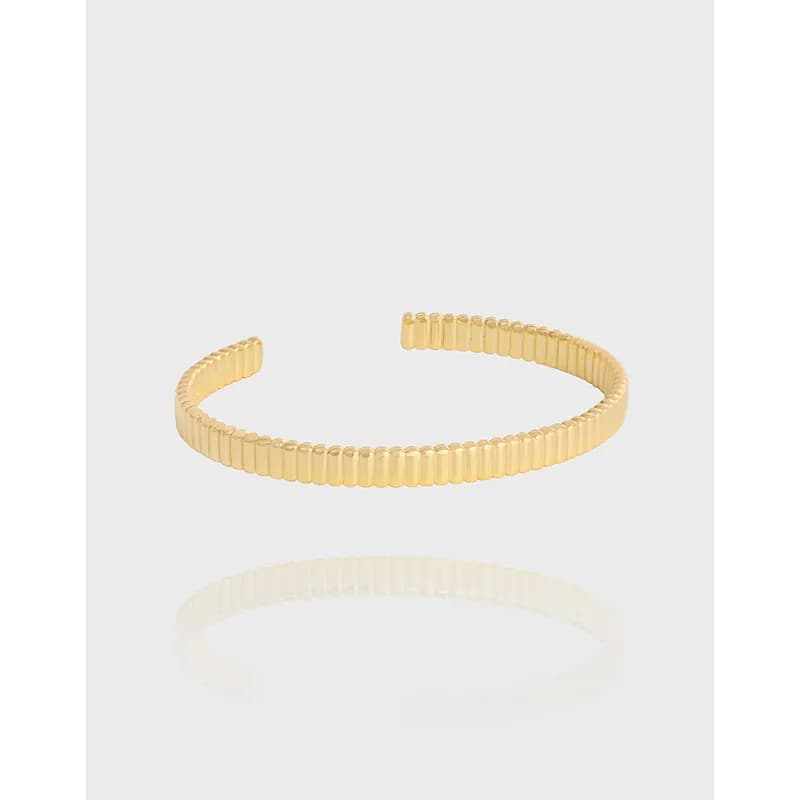Open-ended ribbed bead cuff bracelet in polished silver on a white background.