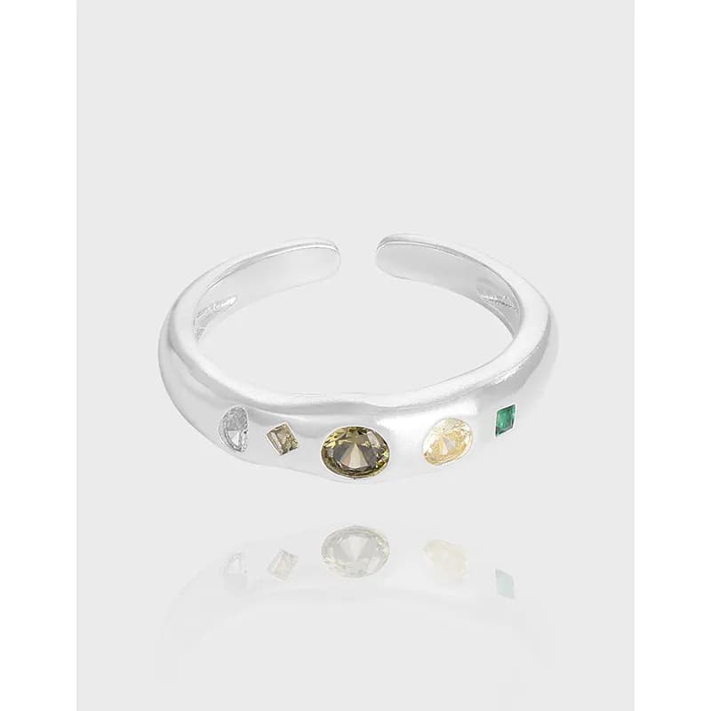Open-band sterling silver ring with a row of mixed-cut gemstones along the top