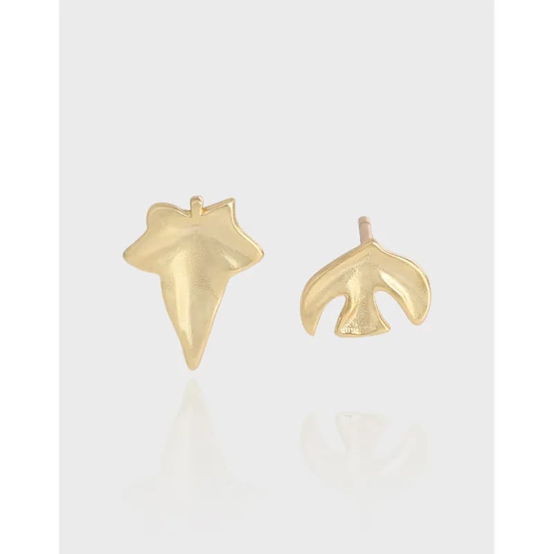Polished sterling silver leaf and abstract star studs shown side by side on a light background.