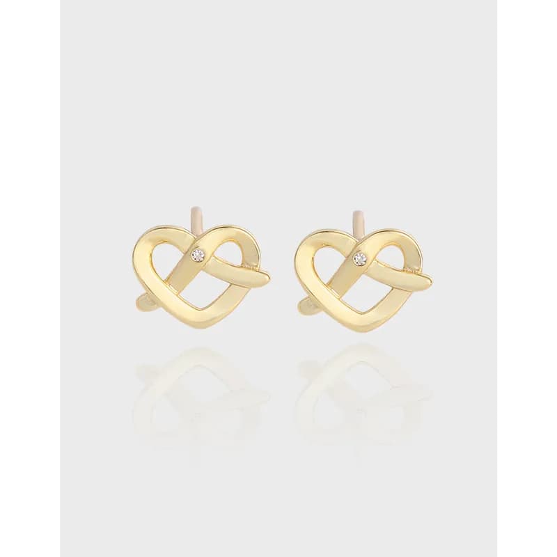 Pair of polished sterling silver interlocking heart earrings with a small stone accent