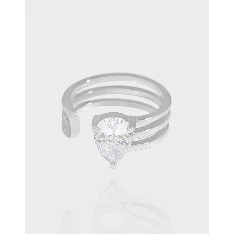 Sterling silver triple-band ring with a pear-cut stone at the center.