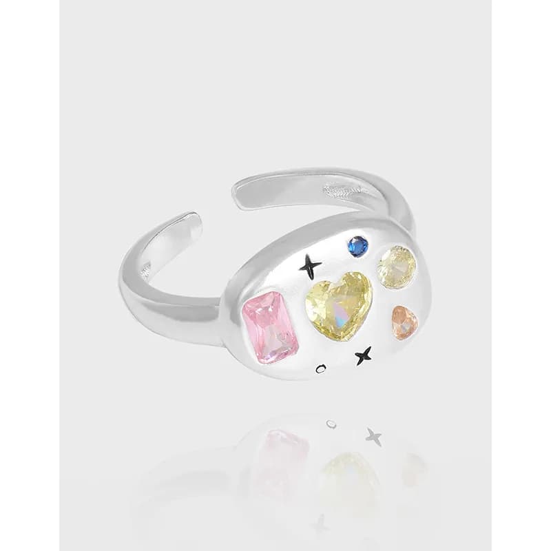 Polished sterling silver open-ring with a colorful gemstone cluster on a rounded face.