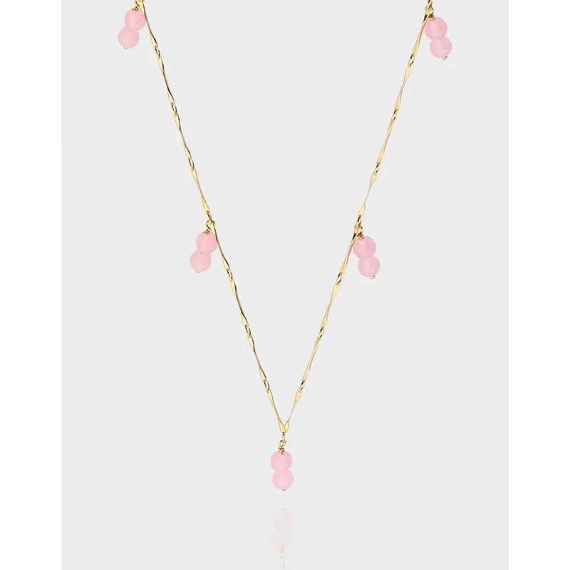 Polished sterling silver necklace with pink bead accents and a pink bead drop pendant on a delicate chain.