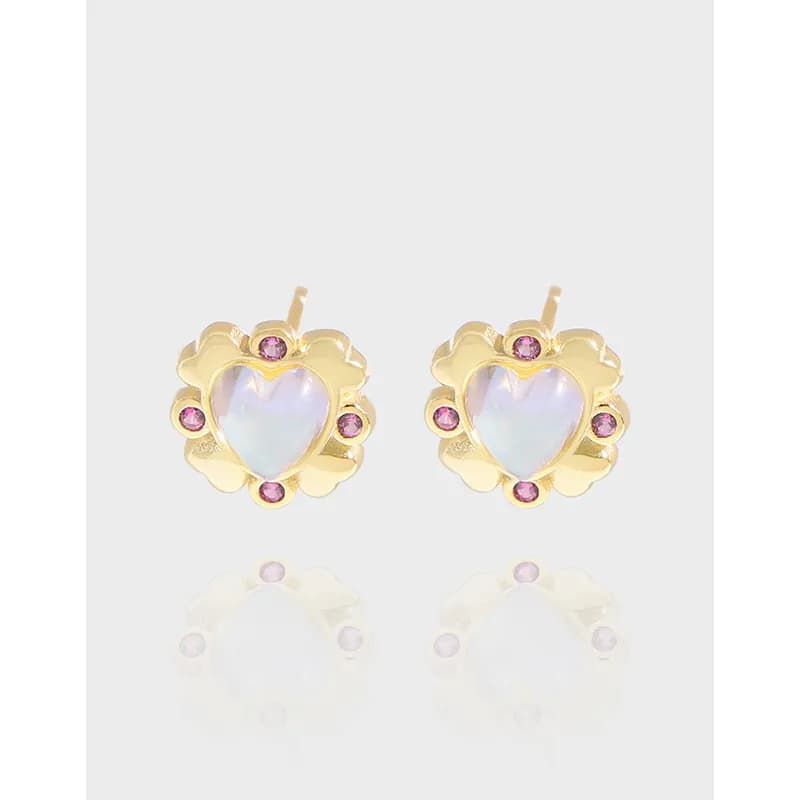 Gold-tone flower-shaped stud earrings with heart-shaped iridescent center and pink accent stones.