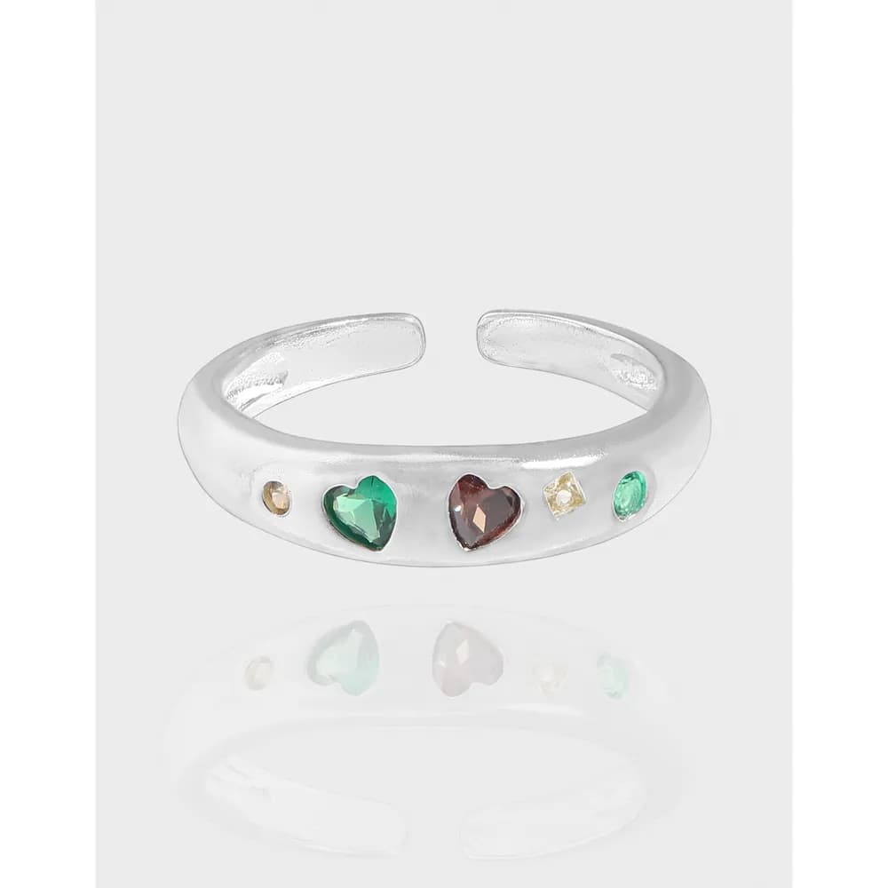 Polished sterling silver ring with five colored heart-cut stones along an open curved band.
