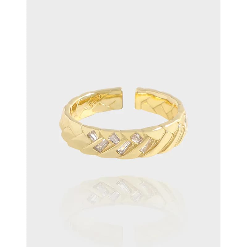 Polished sterling silver ring with geometric leaf facets and small stones on top