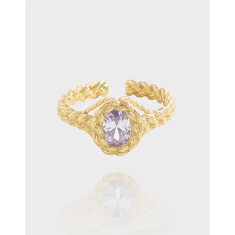 Polished sterling silver ring with a twisted rope band and an oval lavender gemstone center.