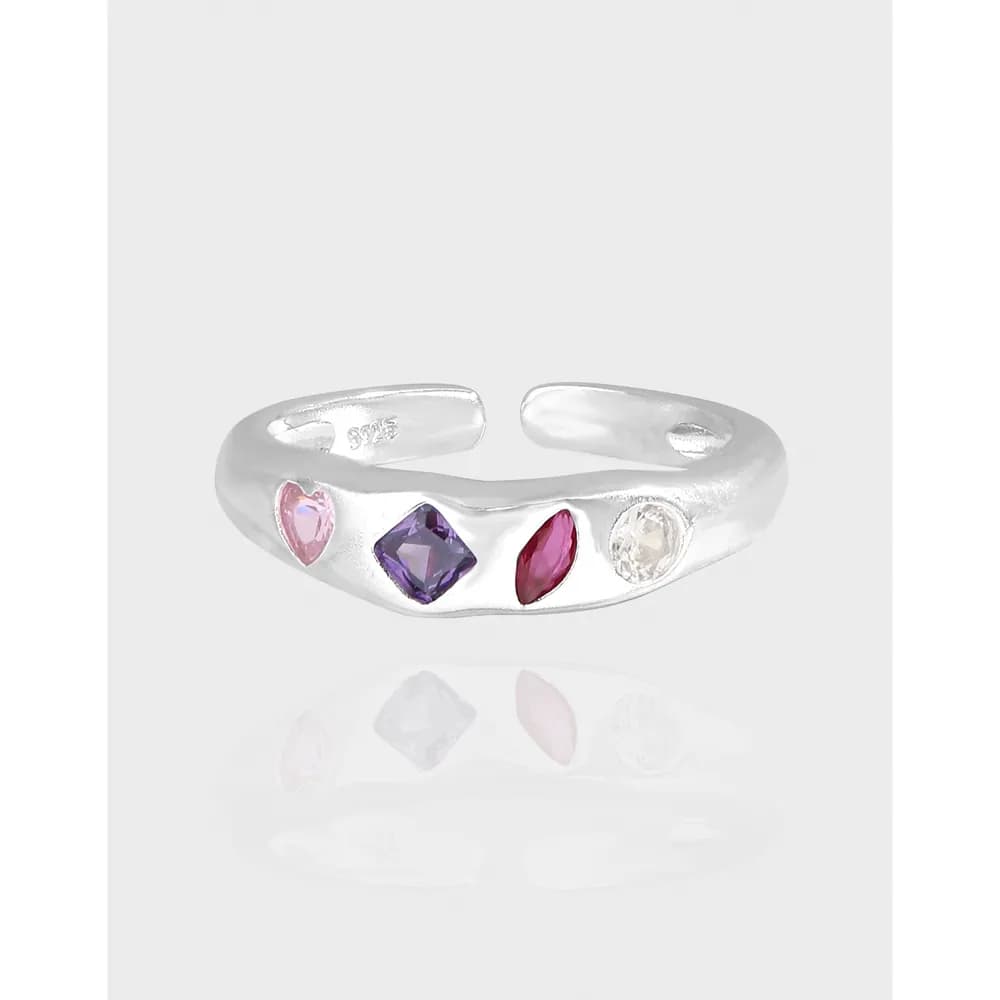 Polished sterling silver ring with four colorful gemstone accents along the front