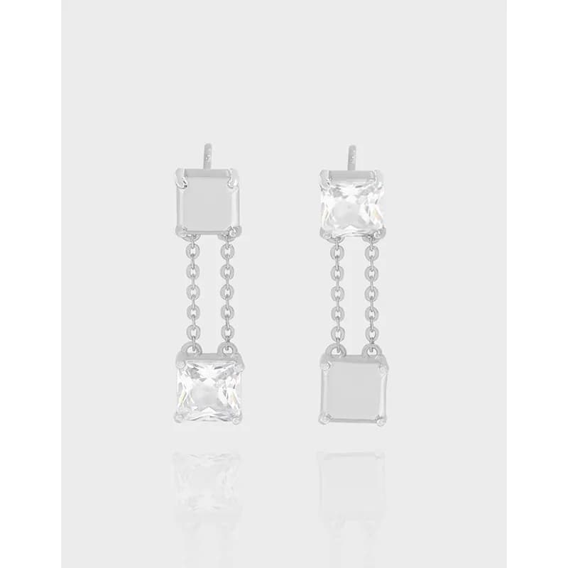 Silvery drop earrings featuring two square-cut stones linked by a chain, polished to a bright finish.