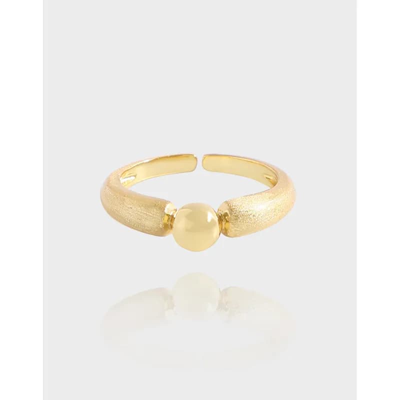 Open curved sterling silver ring with a central smooth bead between textured ends.