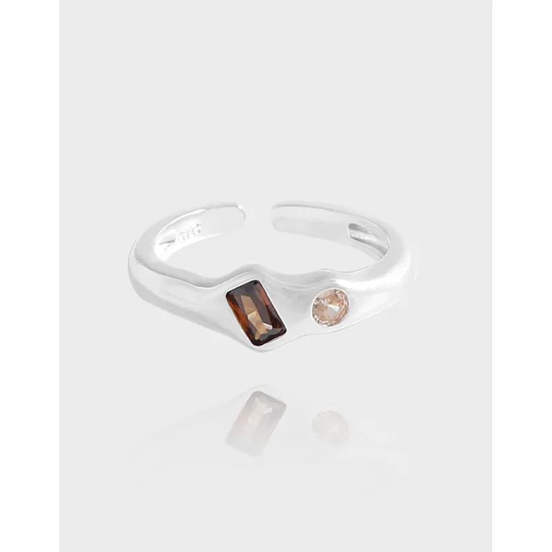 Sterling silver open-band ring with rectangular brown gem and small round pale gem on the top.