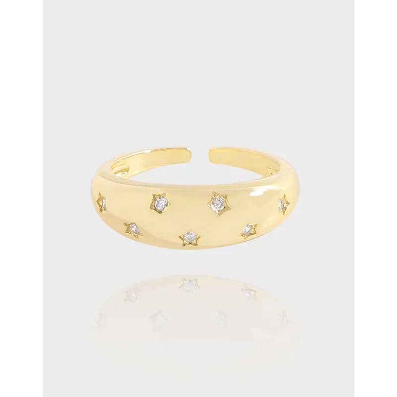 Polished sterling silver ring with star-shaped settings along the exterior of the band.