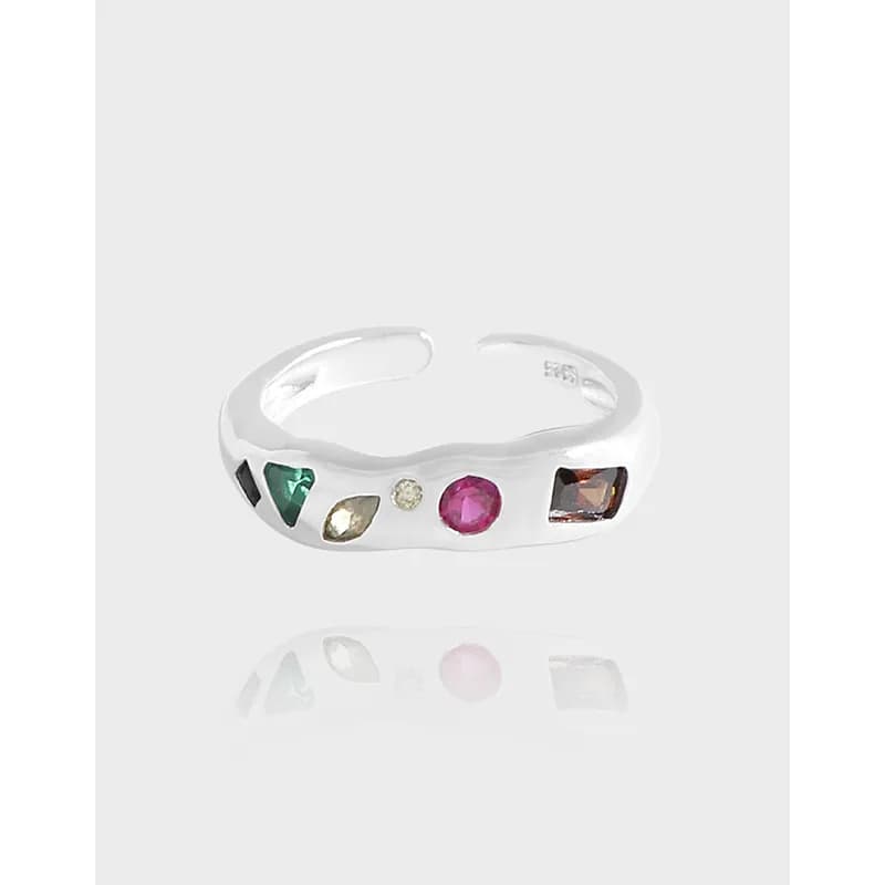 Polished sterling silver ring with a row of bezel-set colorful gemstones along the band.
