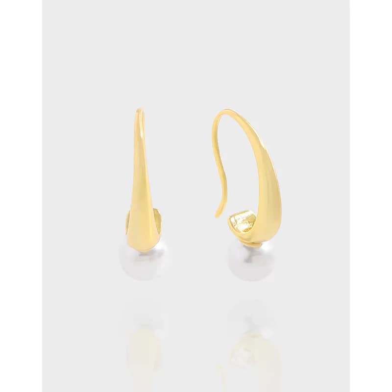 Polished sterling silver teardrop-shaped earrings with a curved silhouette and subtle reflection.