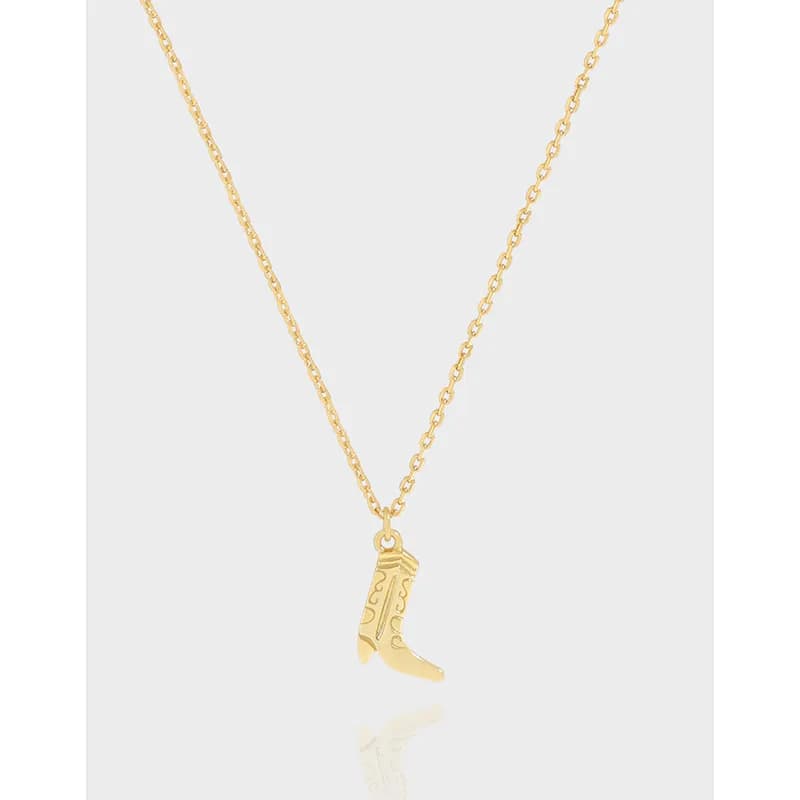 Delicate silver chain with a small boot charm pendant hanging in the center.