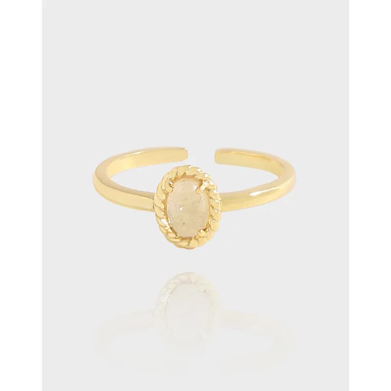 Open sterling silver ring with an oval centered stone and a rope-edge bezel on a polished band.