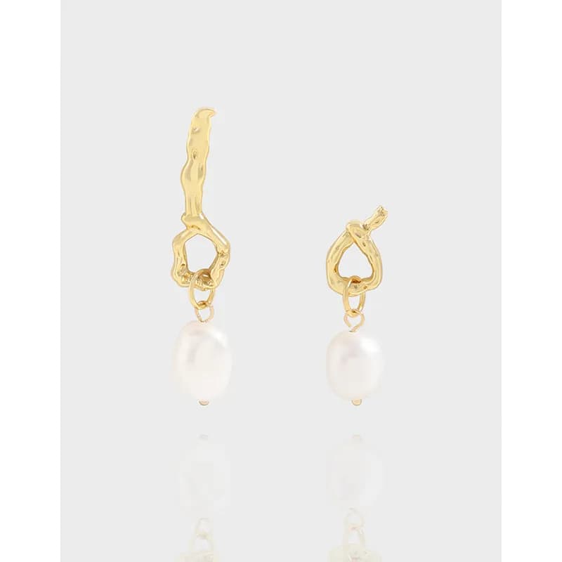 Two irregular textured hoop earrings with dangling freshwater pearls on a light background.