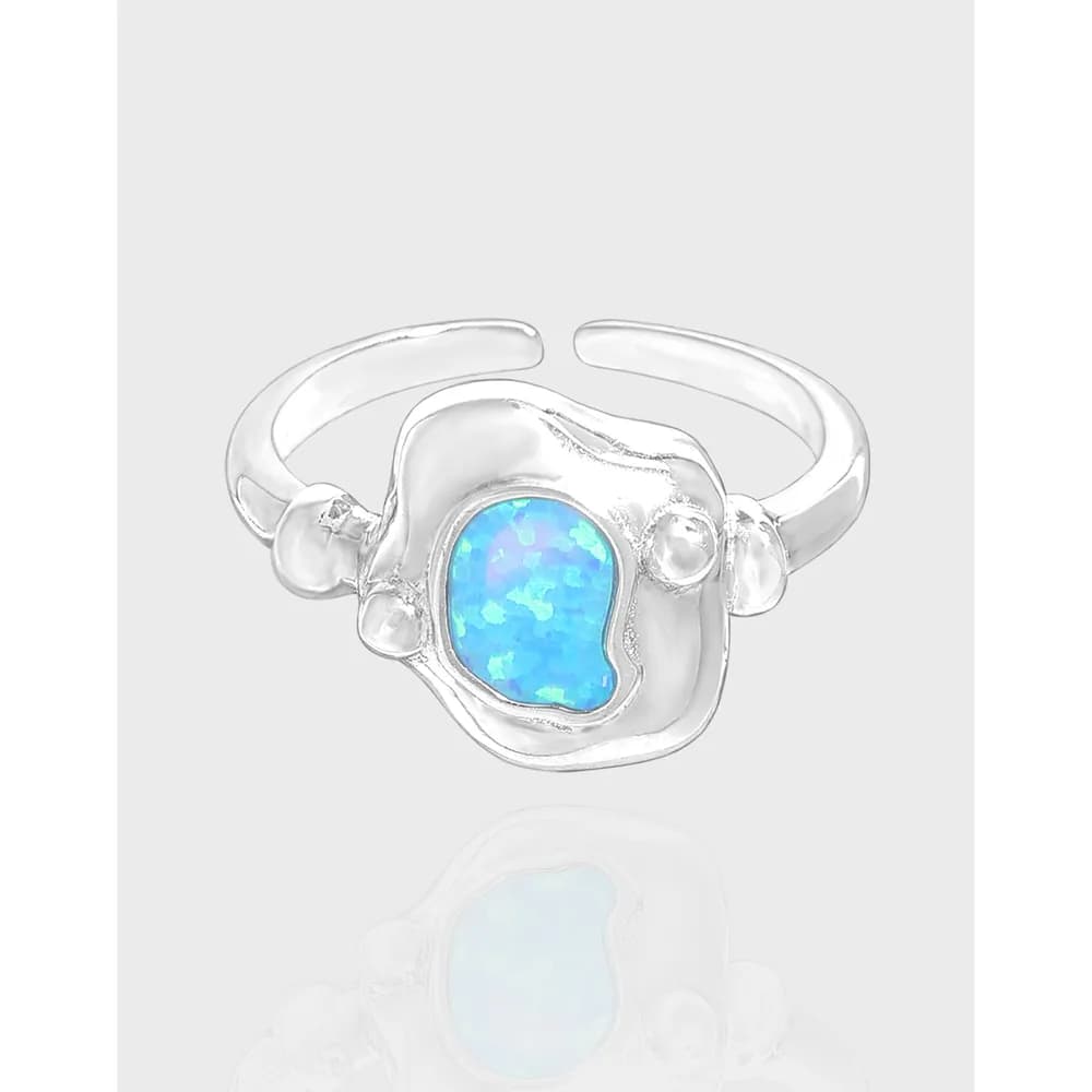 Sterling silver ring with an irregular organic setting and a bright blue opal centerpiece.
