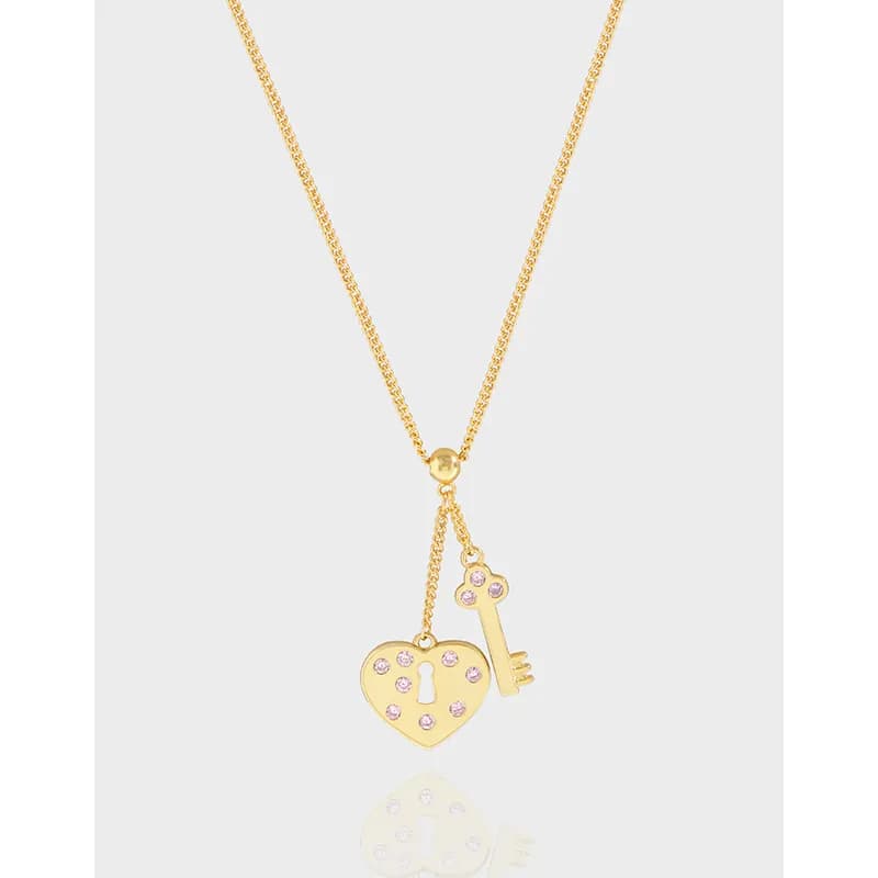 Polished sterling silver necklace with heart lock and pink-crystal key charms hanging from a delicate chain.