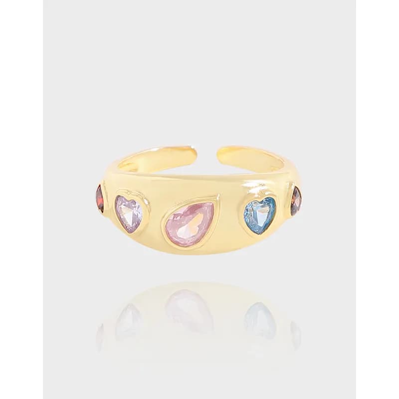 Polished sterling silver ring with multicolor heart-shaped stones mounted along the band.