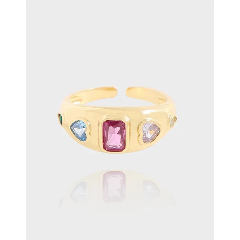 Polished sterling silver ring with a central pink rectangular stone and surrounding colored gems on an open-band setting.