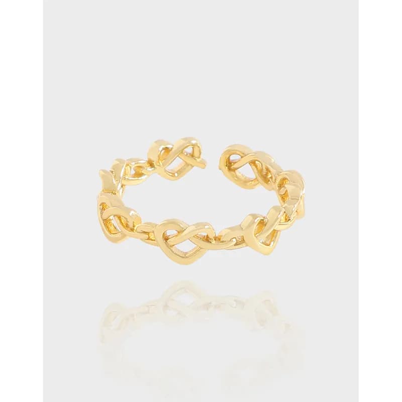 Polished chain-link ring with interlocking loops on a white background.