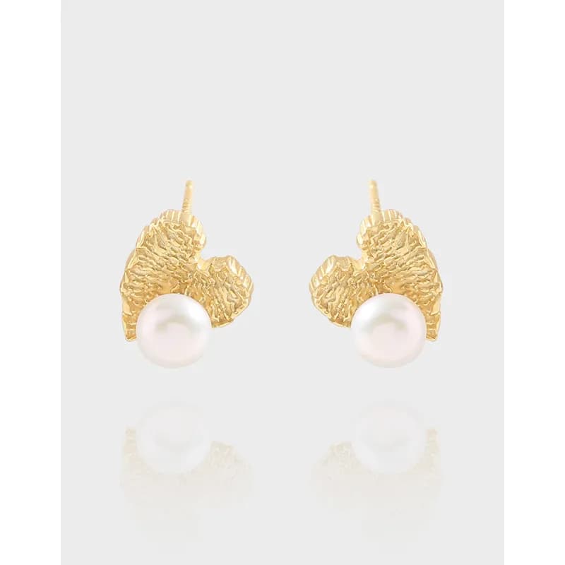 Pair of textured leaf-shaped earrings with a single pearl drop on polished silver
