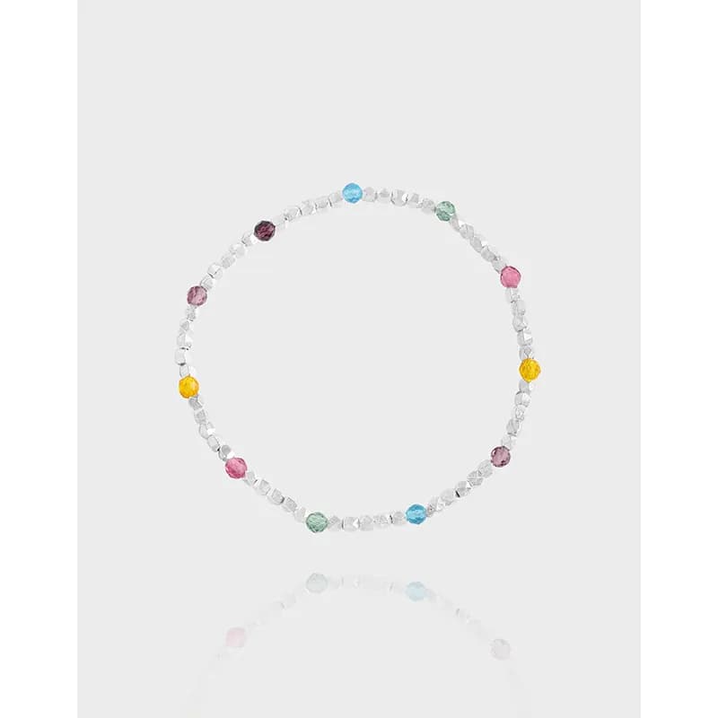 Polished sterling silver bracelet with colorful round beads arranged around a thin band.