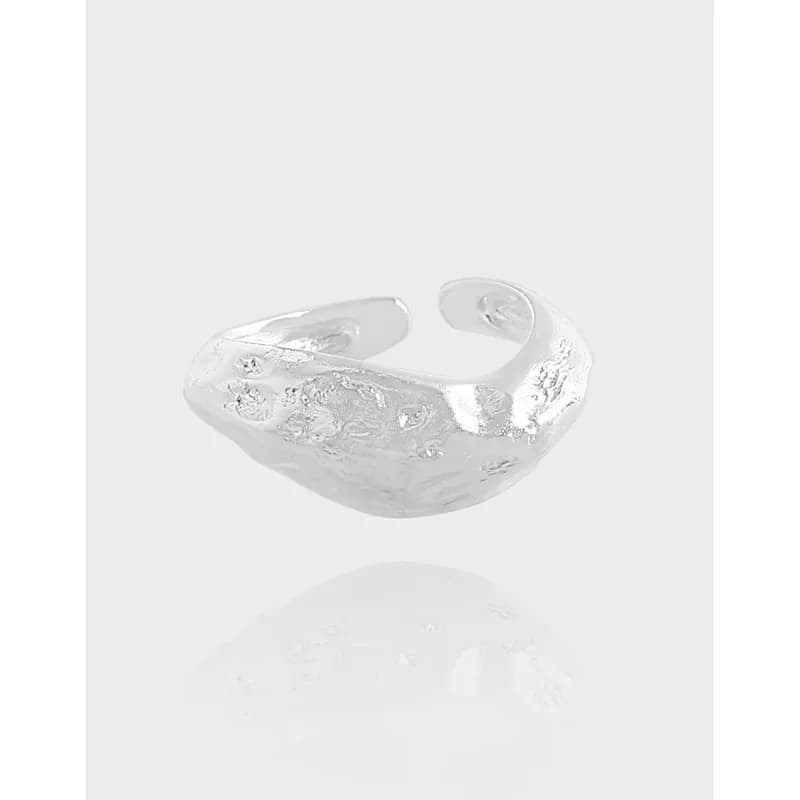 Open-ended sterling silver ring with a textured, hammered surface.