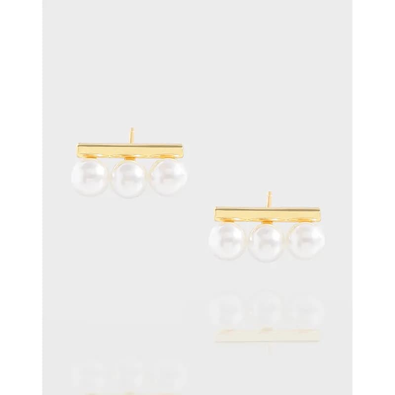 Polished sterling silver earrings with a horizontal bar and three hanging white pearls.