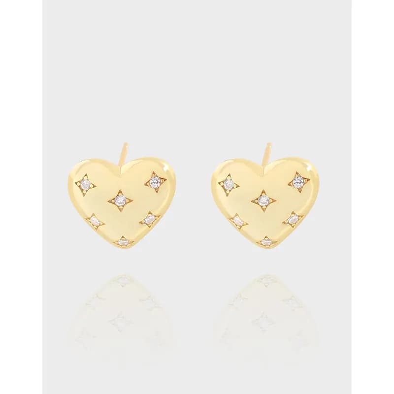 Pair of polished sterling silver heart-shaped stud earrings with small stones on a white background.