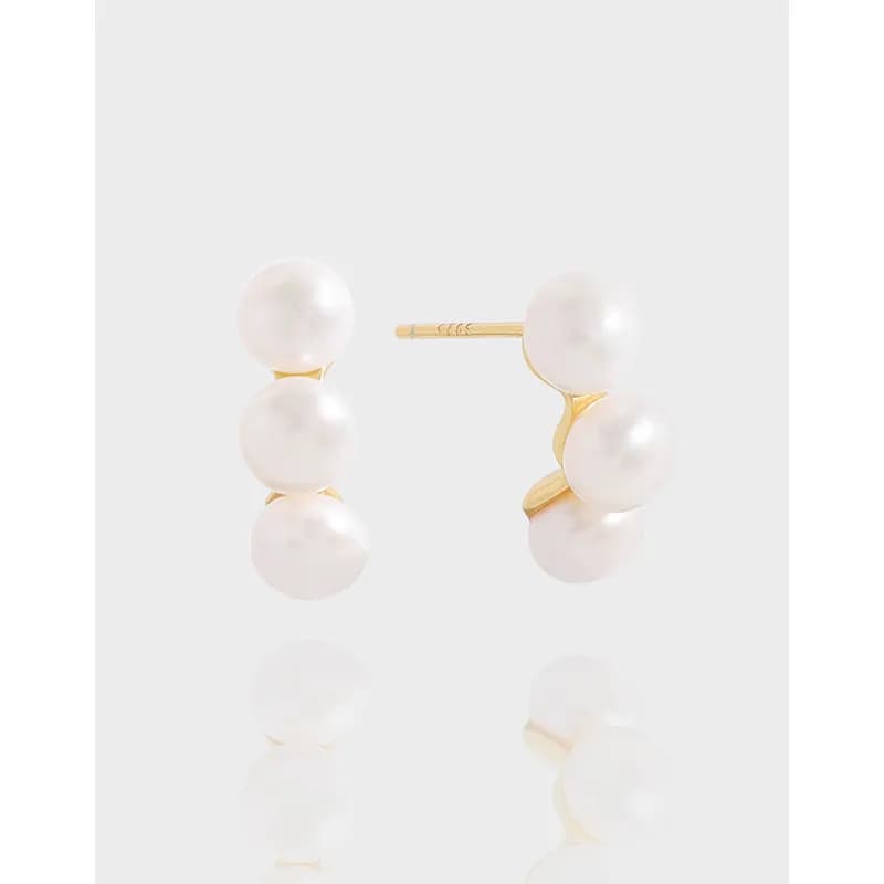 Polished sterling silver triple pearl hoop earrings with a curved pearl arrangement.