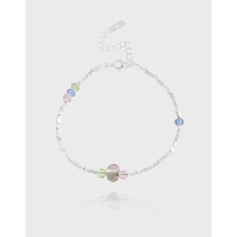 Polished sterling silver bracelet with pastel faceted beads arranged along a delicate chain and a lobster clasp