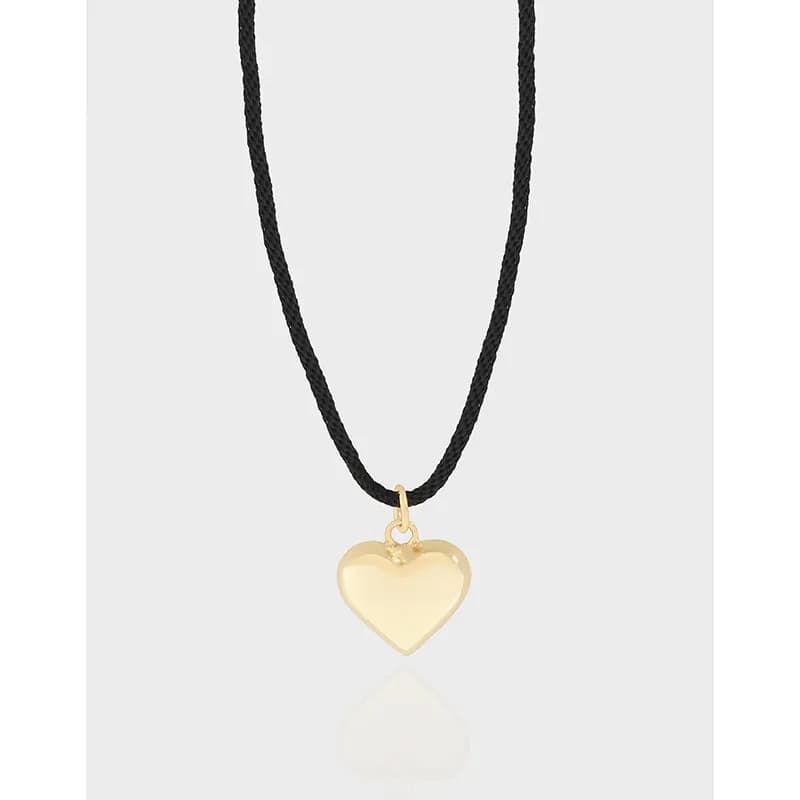 Polished sterling silver heart pendant on a black cord necklace