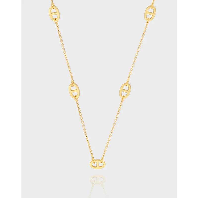 Polished sterling silver necklace featuring spaced open oval links with a central oval pendant on a thin chain.