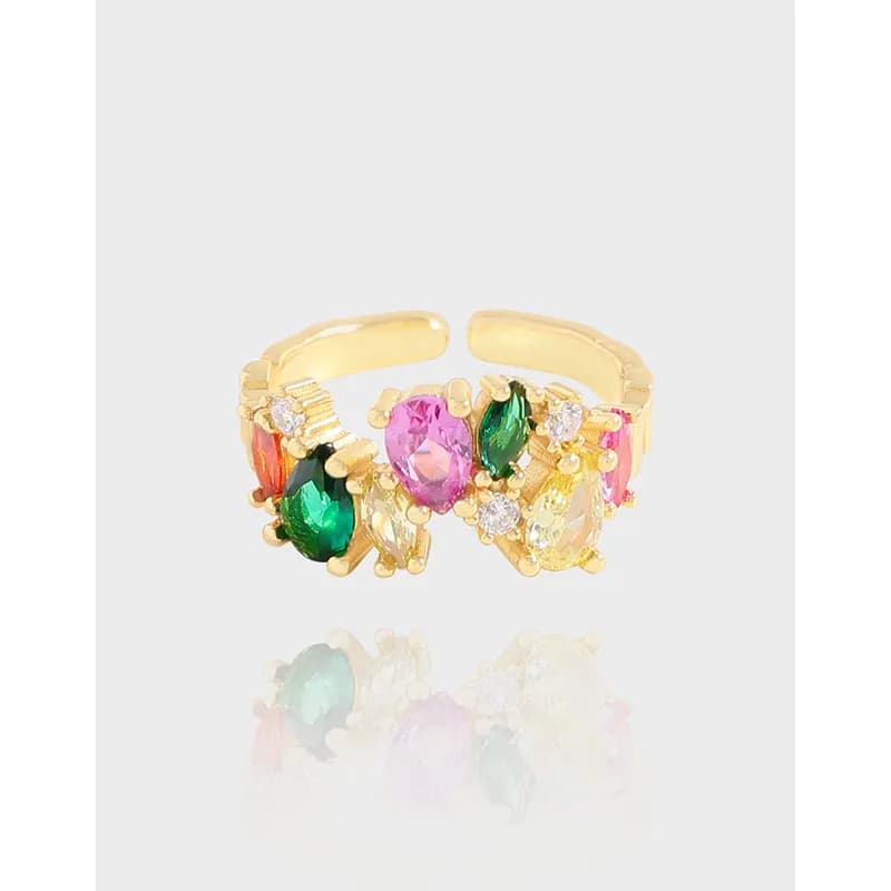 Polished metal ring with a colorful gemstone cluster in a leafy, open-work design.