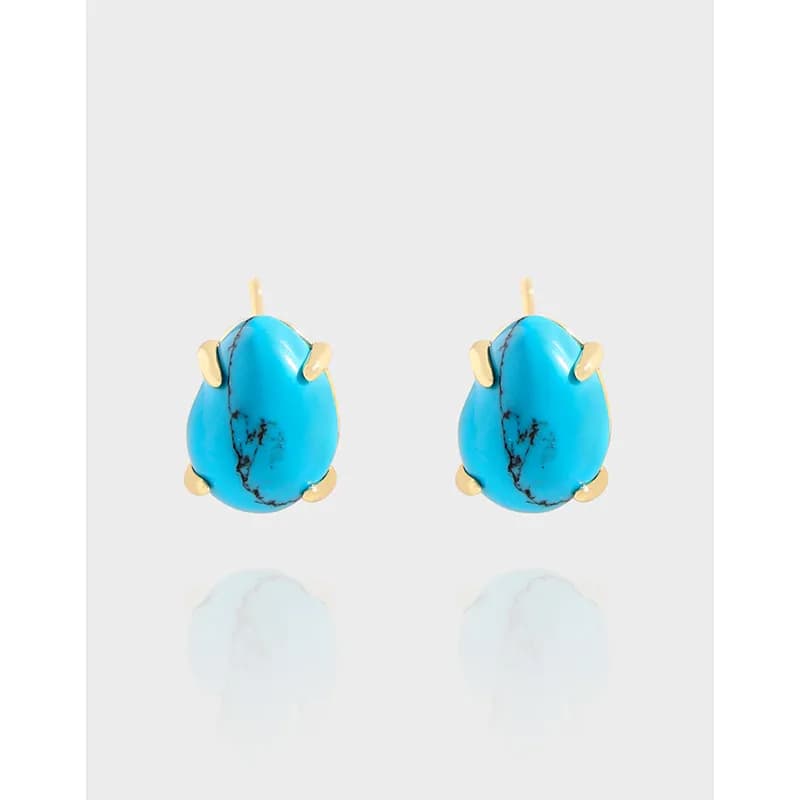 Pair of turquoise oval stud earrings with polished sterling silver settings and prongs